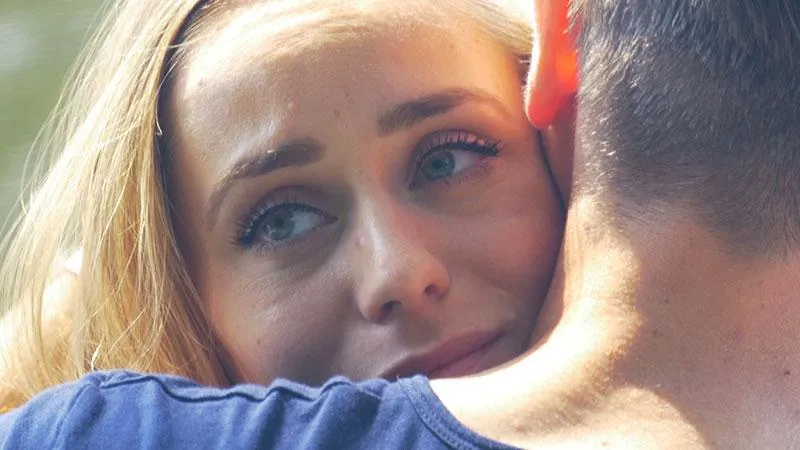 Upset woman hugging man