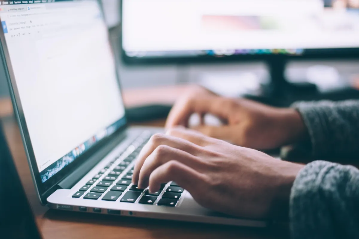 A person typing a mission statement