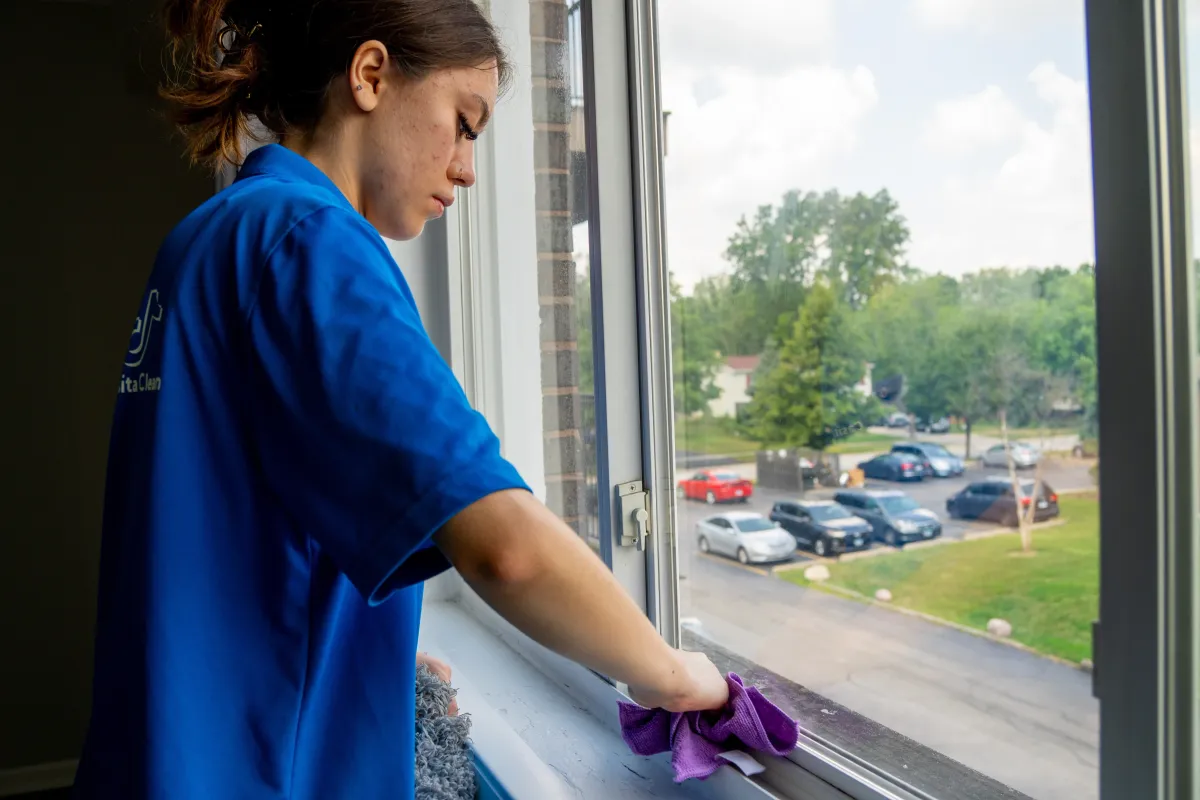Professional Cleaner Dusting a Window Sill in Lisle, IL