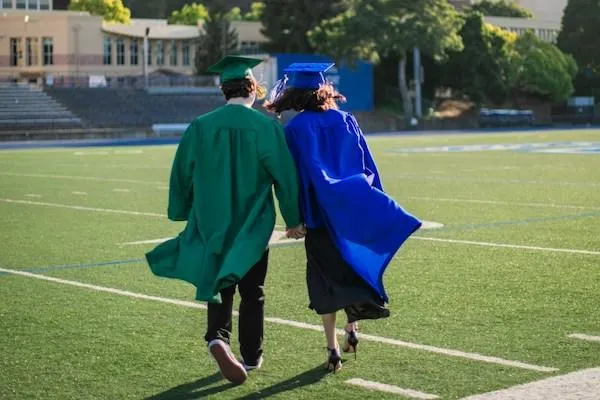 Two students celebrating their graduation