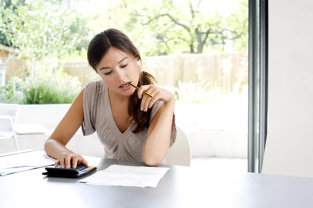 woman looking over papers