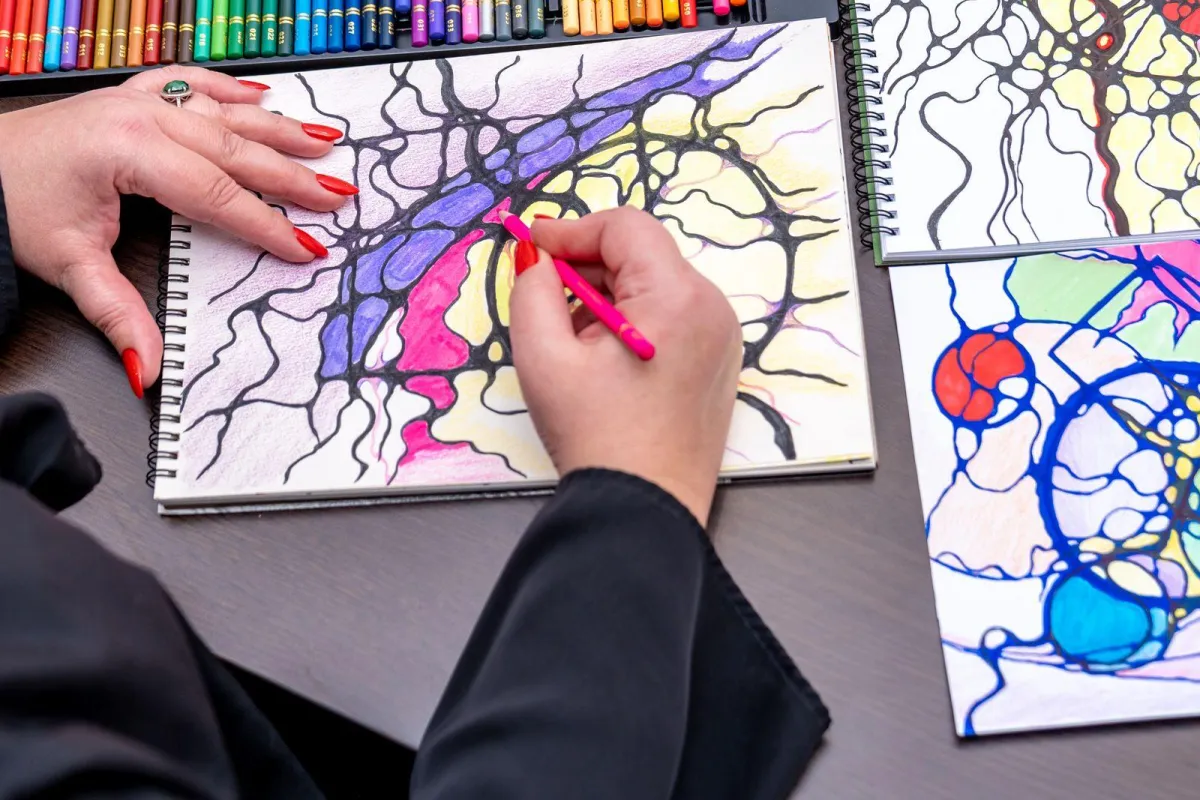 woman coloring with colored pencils