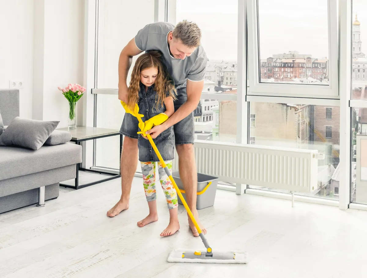 dad and daughter mopping floor