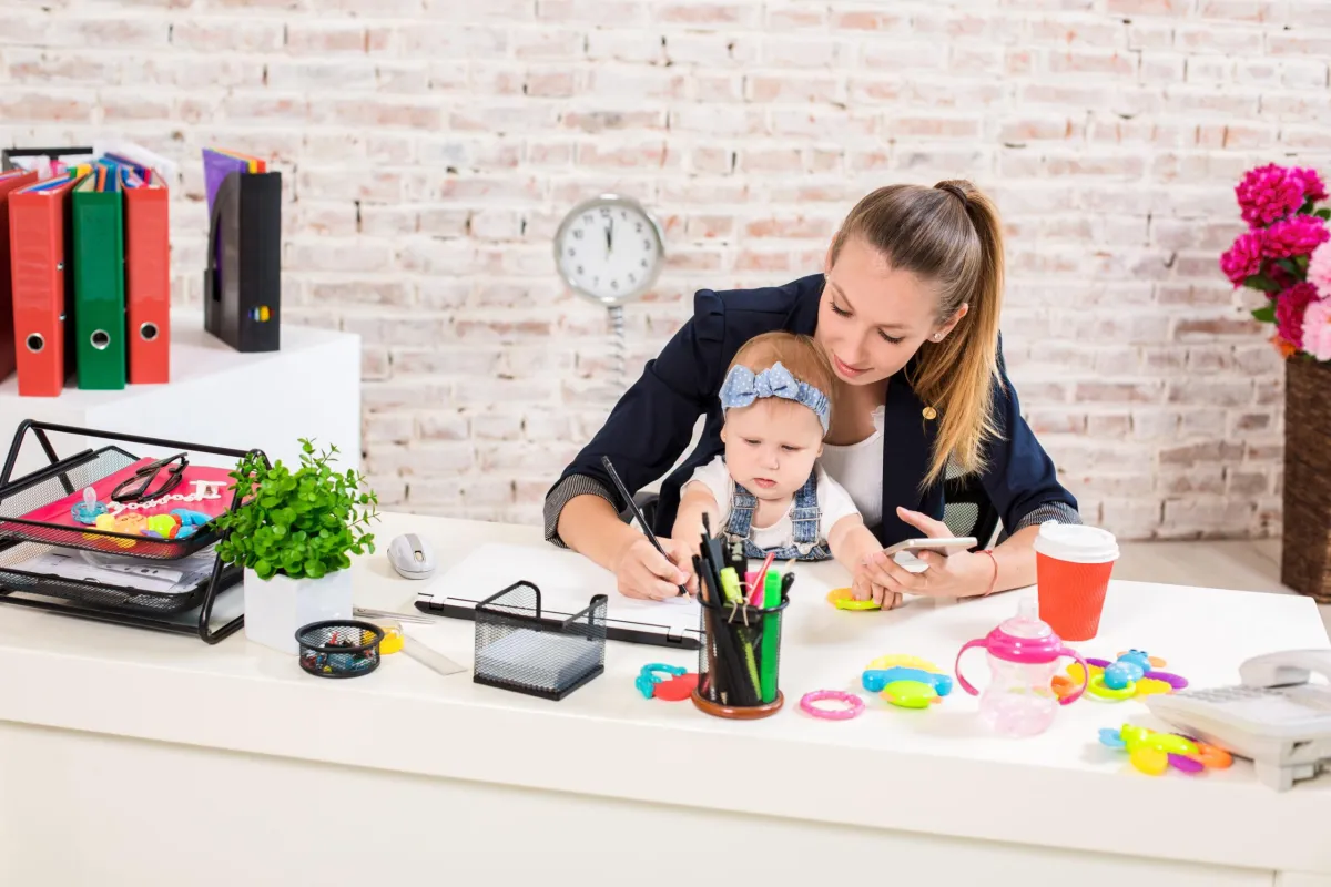 mom working with toddler on her lap