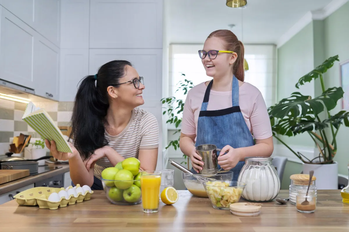 mom and daughter cooking in the kitchen