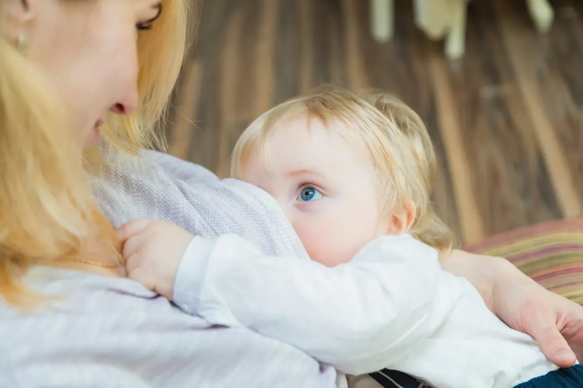 mom looking down at toddler while he nurses