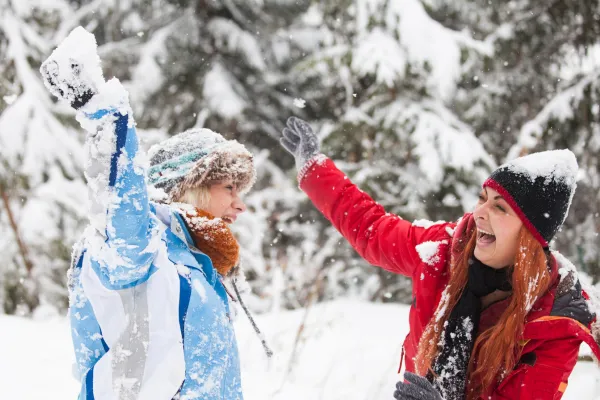 Moms experiencing joy in a snowball fight