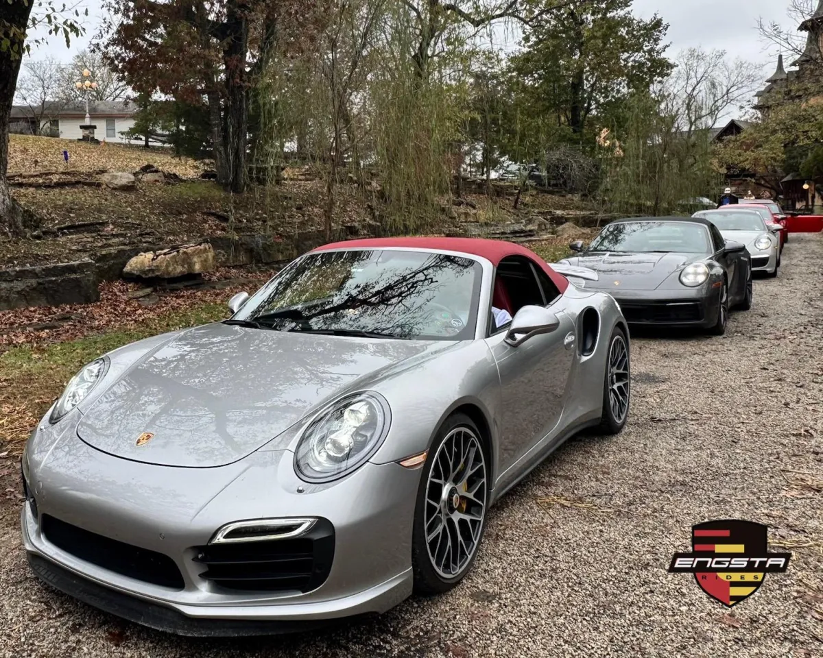 row of Porsches parked