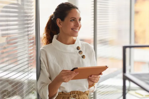 woman with ipad smiling