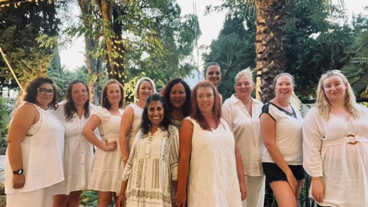 group of women on a retreat all wearing white