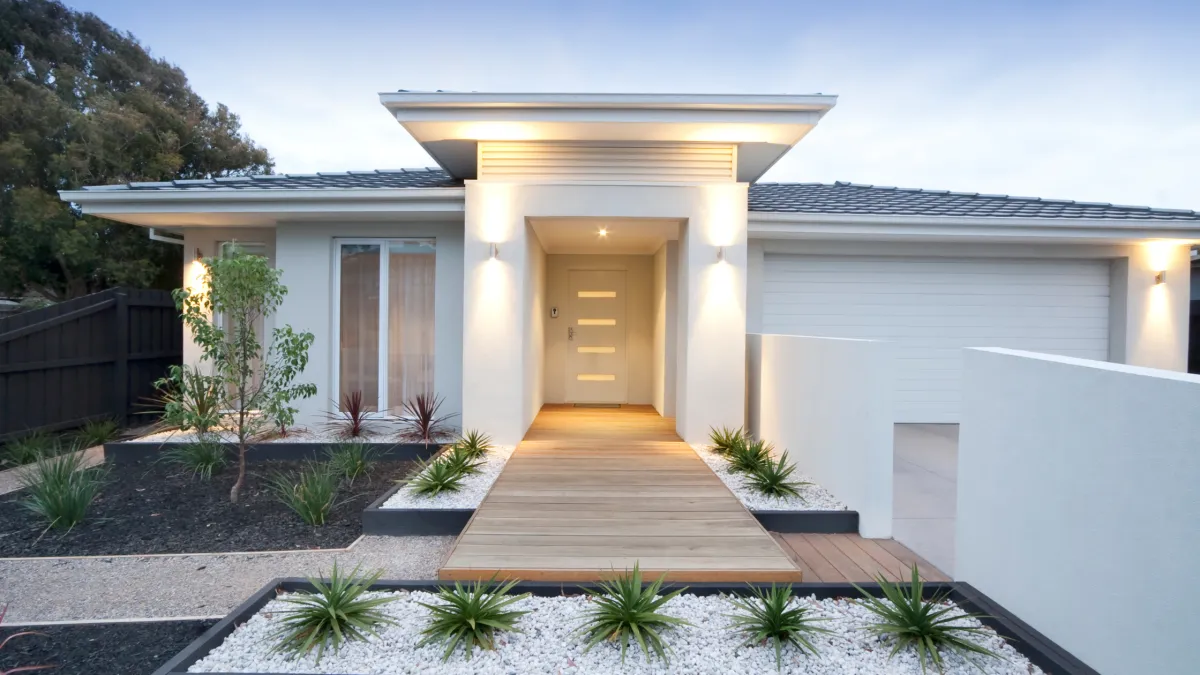 Modern white exterior house with contemporary design featuring clean lines and warm lighting, showcasing professional exterior painting ideas for Mildura homes