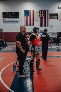 Female fighter in a powerful stance, emphasizing the connection between intense training and the menstrual cycle. 🥊💪