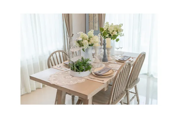 Country-style dining table arranged for guests, symbolizing intentional seating and hospitality design at a boutique tiny-home retreat.