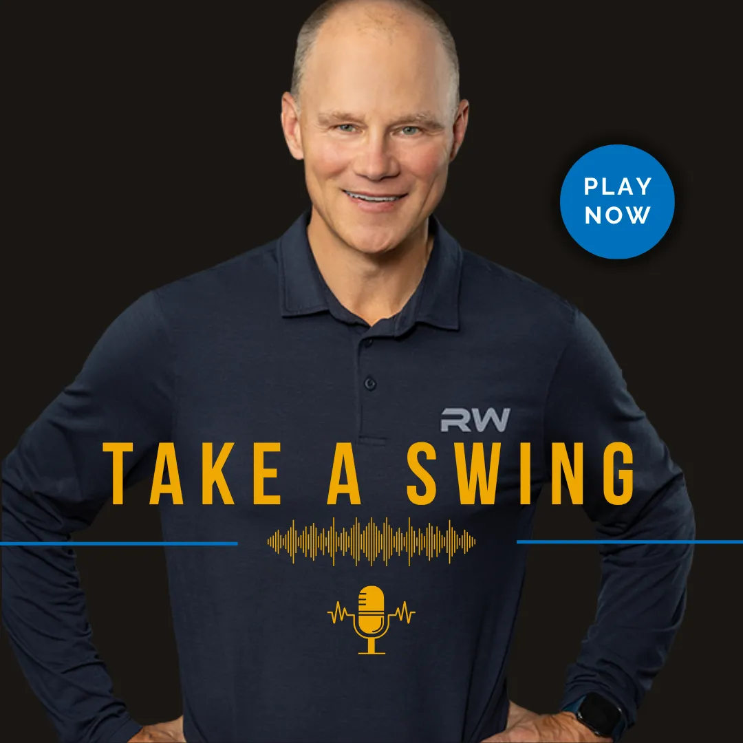 Photo of a smiling Ron Wuotila in a navy polo shirt with 'RW' embroidered on the chest, standing with hands on hips against a black background. Bold yellow text across the image reads 'Take a Swing' above a yellow microphone icon and soundwave graphic. A blue circular button in the top right says 'Play Now' in white text.