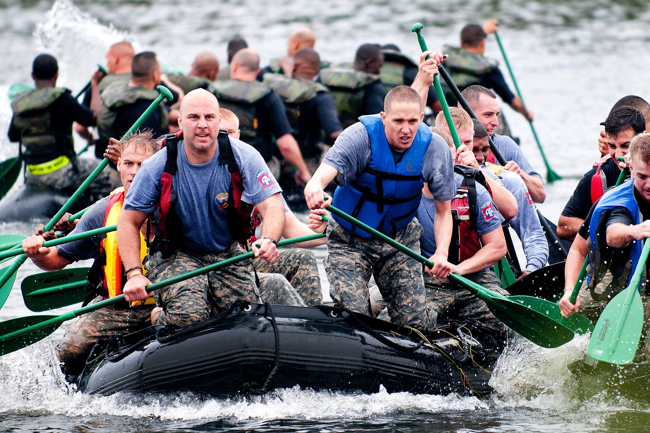 soldiers in a group paddling on a boat in a military training scenario