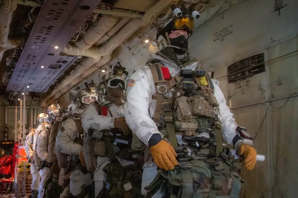soldiers standing in a line in full gear completing a training exercise