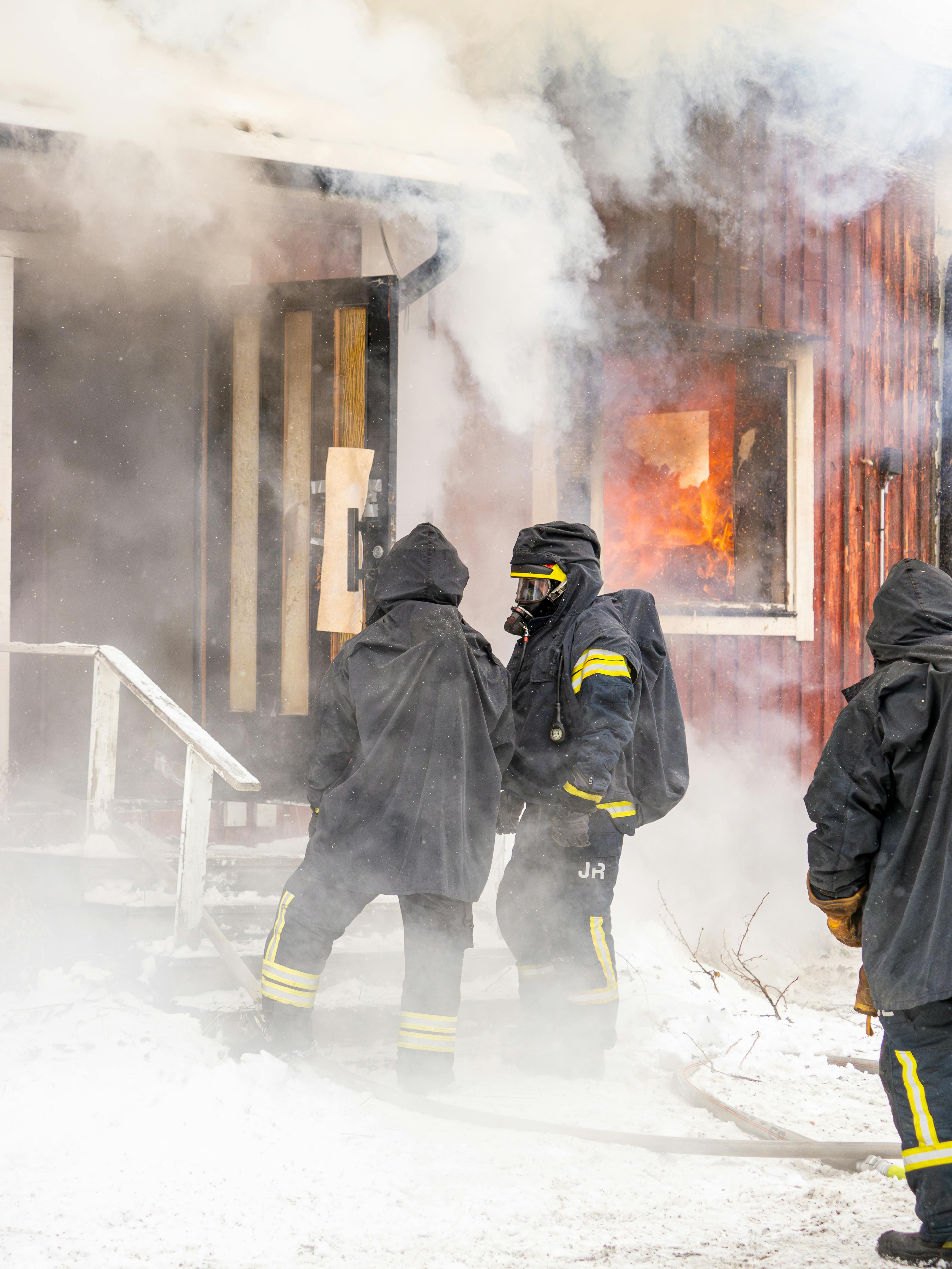 Firefighters in turnout gear at a house fire showing fireground durability demands
