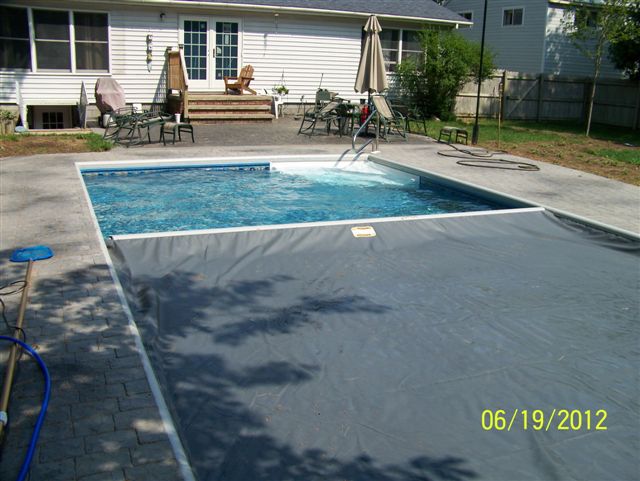An automatic cover on an inground pool