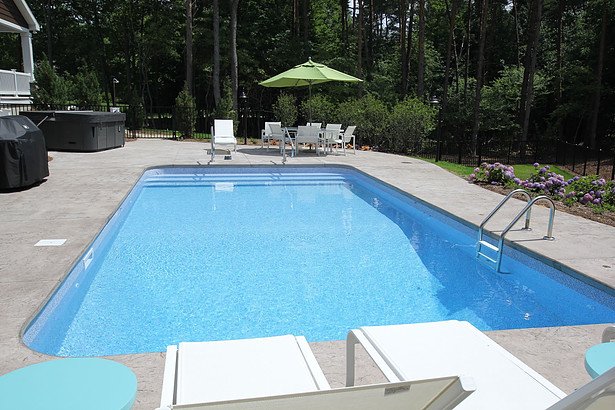 A beautiful pool deck surrounding an inground pool