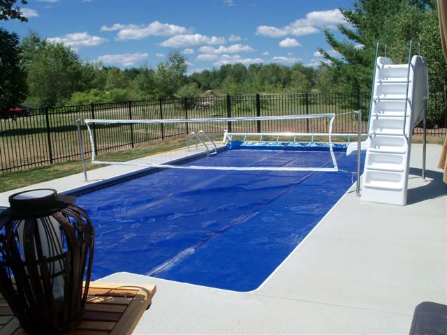 A covered pool with a volleyball net