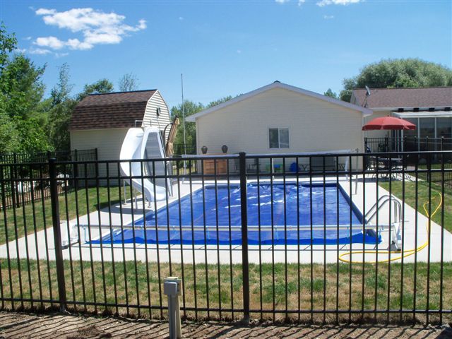 A covered inground pool with a slide