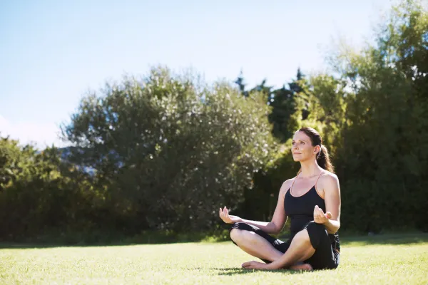 Image of a person practicing mindfulness in nature or a peaceful setting.