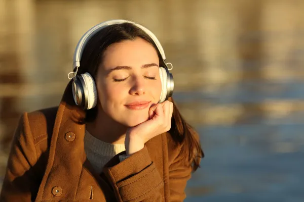 Image of a person listening to music, playing an instrument, or dancing.