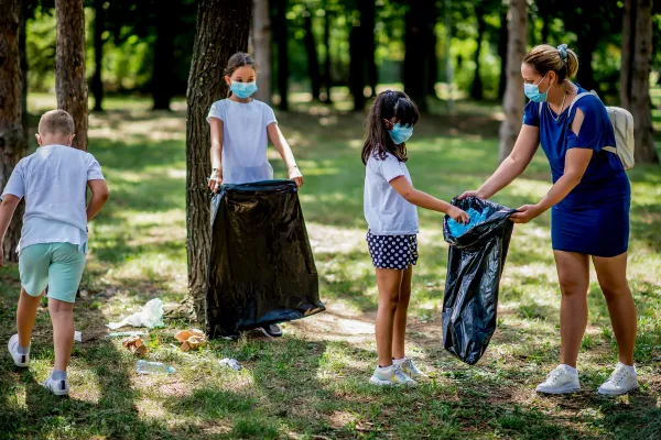 Image of people volunteering in their community, such as helping at a soup kitchen, cleaning up a park, or mentoring children.