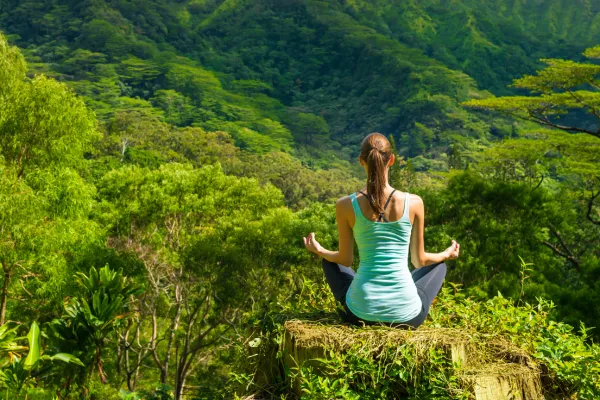 Image of a person meditating in a peaceful setting.