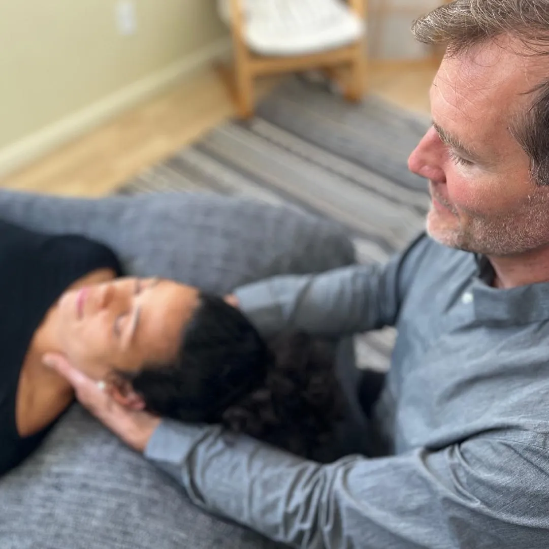 Jared using cranial sacral therapy on a woman