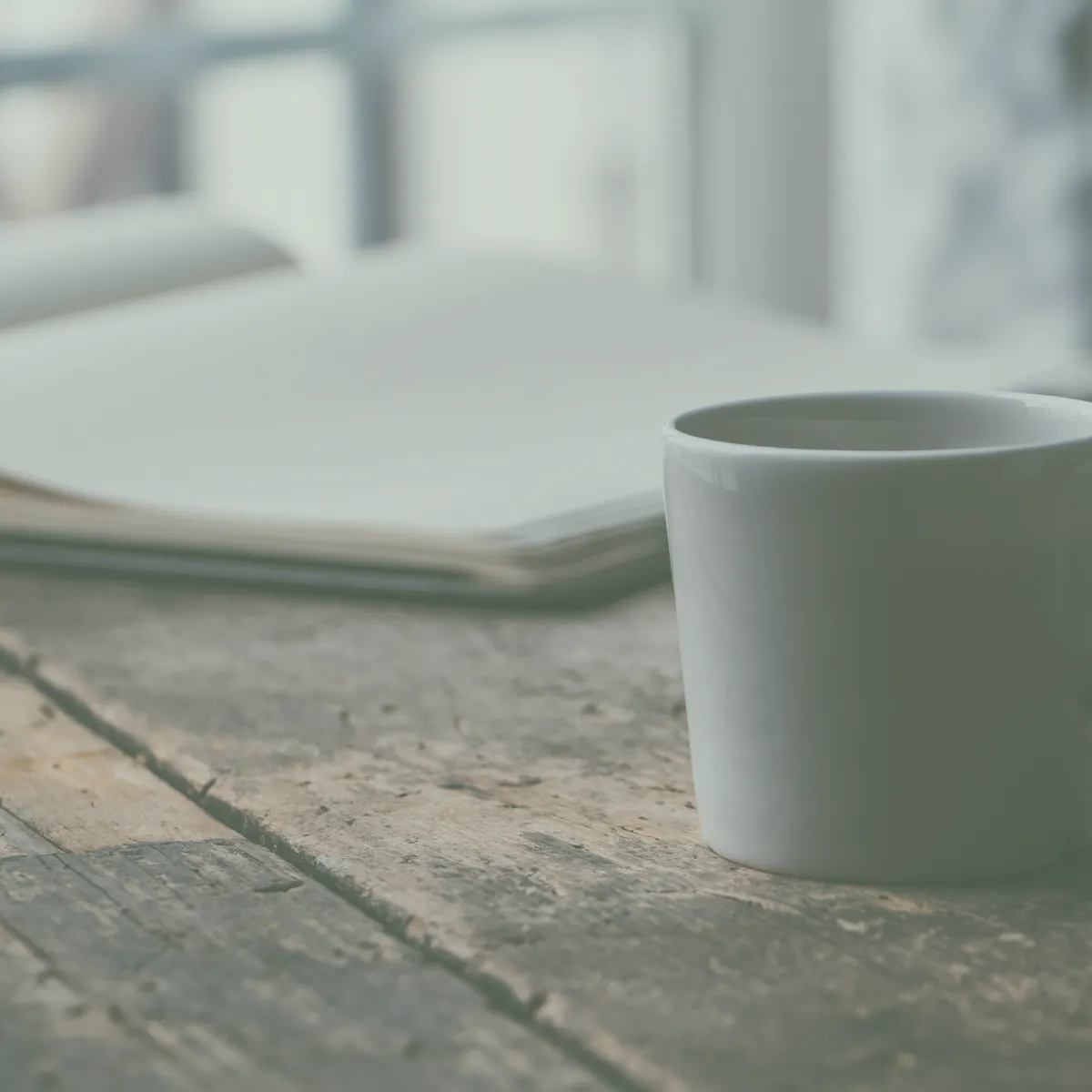 Cup of tea and a notebook on a table