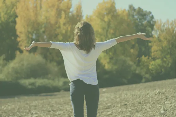 Woman with open arms accepting the world