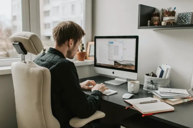 A business owner focuses on high-impact work while routine tasks are outsourced, illustrating how delegating the right responsibilities helps entrepreneurs scale efficiently in 2026.