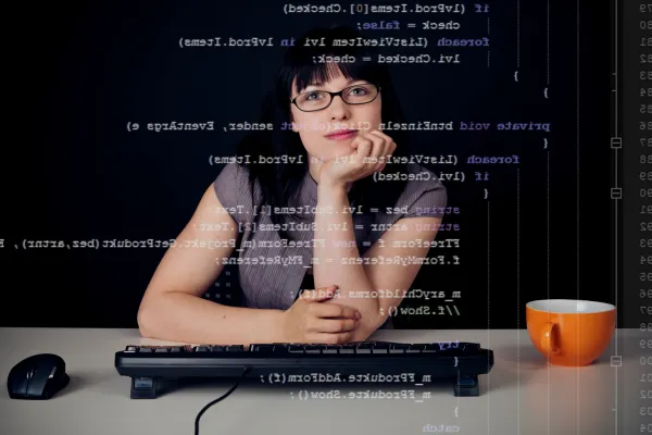 Woman analyzing data dashboard in modern automotive office, symbolizing innovation and leadership in automotive tech.