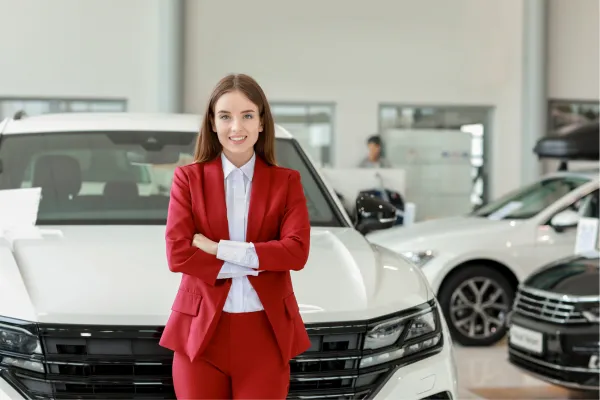 Confident woman in automotive dealership