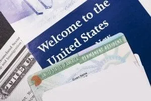 U.S. permanent resident card on top of a “Welcome to the United States” booklet.