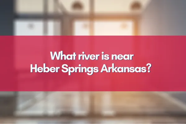 Scenic view of the Little Red River flowing near Heber Springs, Arkansas, surrounded by lush greenery and clear blue skies.
