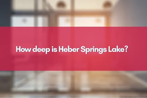 Aerial view of Heber Springs Lake surrounded by lush greenery under a bright blue sky