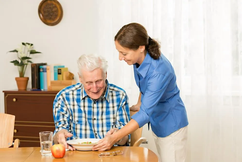 Caregiver helping senior man with daily activities in Studio City