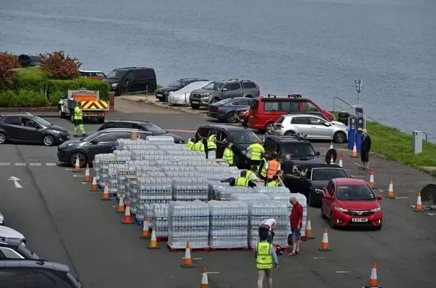 Emergency teams handing out fresh water to people