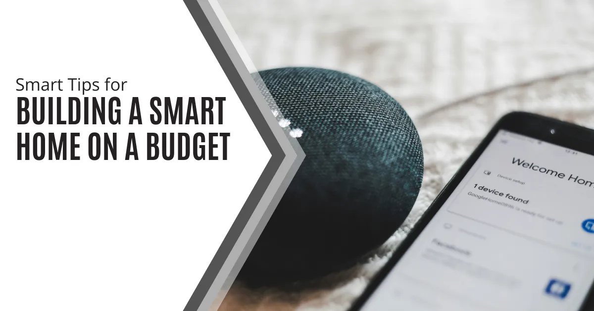 The image features a smart speaker and a smartphone lying on a soft surface, such as a bed or couch. The smartphone screen displays a "Welcome Home" message, indicating that it is ready to set up a smart home device. To the left, there is a white and gray graphic design with the text: "Smart Tips for Building a Smart Home on a Budget." The overall composition suggests a focus on integrating affordable smart home technology.