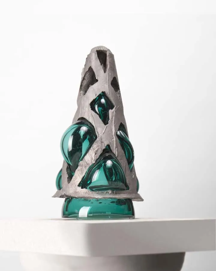 cast aluminum structure with teal glass blown into it - when lit from underneath, angel wings are cast upon the wall