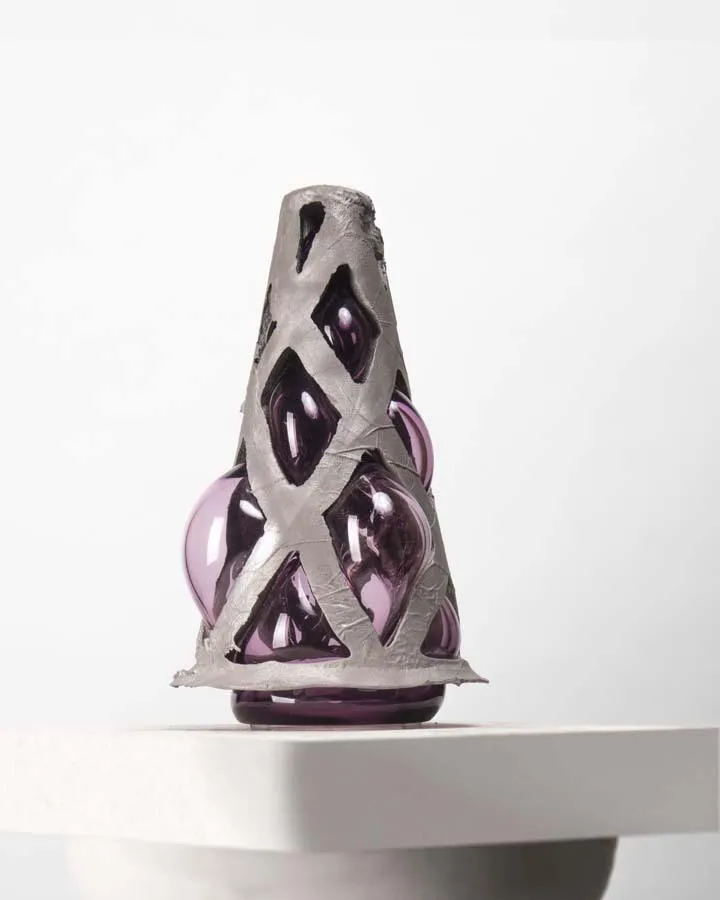 cast aluminum structure with purple glass blown into it - when lit from underneath, angel wings are cast upon the wall