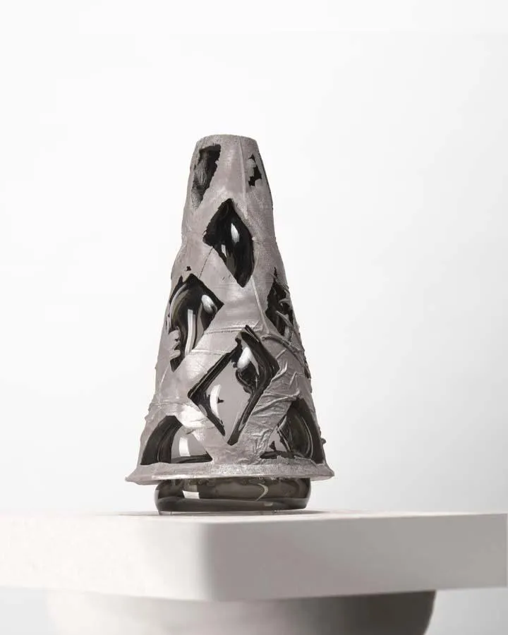 cast aluminum structure with a smoky grey glass blown into it