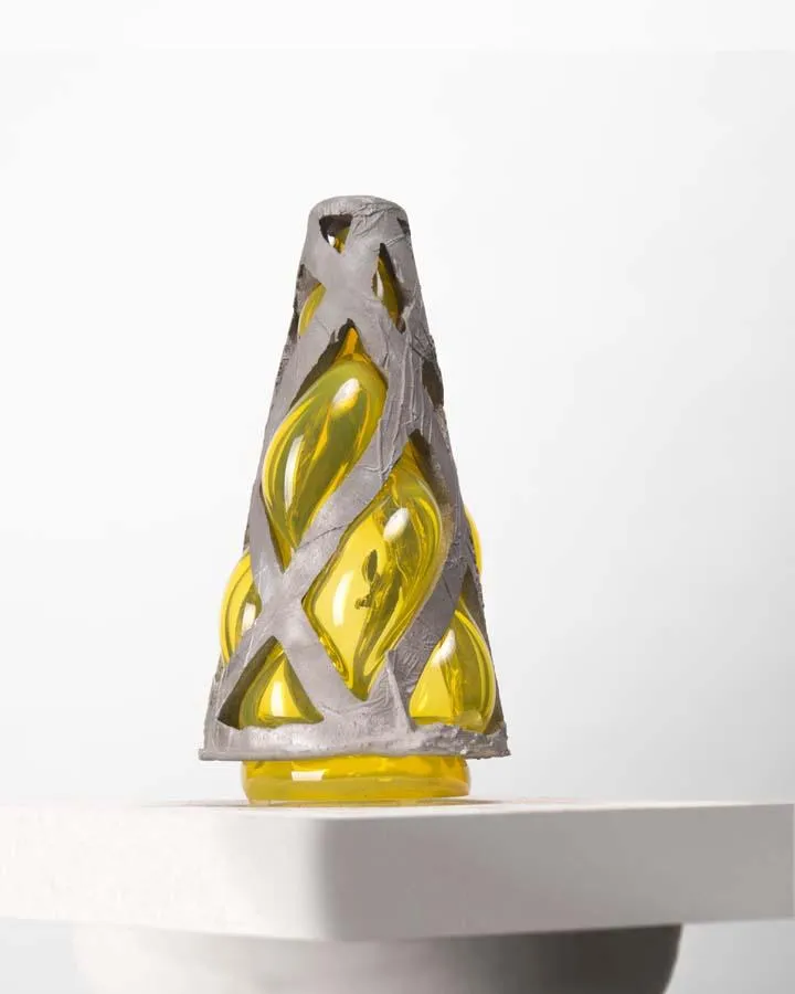 cast aluminum structure with a smoky grey glass blown into it - when lit from underneath, angel wings are cast upon the wall