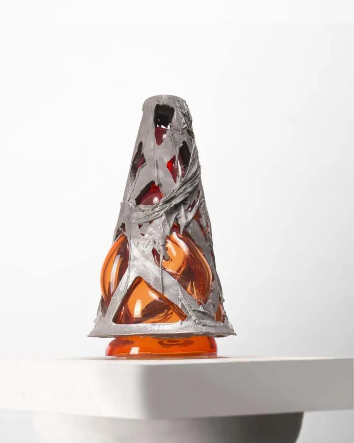 cast aluminum structure with red glass blown into it - when lit from underneath, angel wings are cast upon the wall