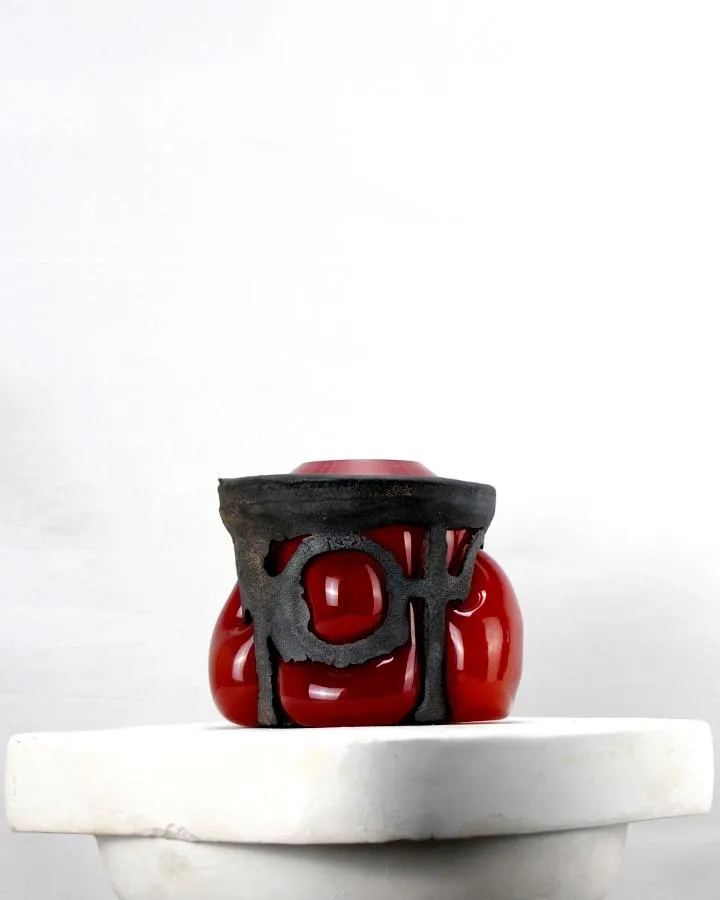 cast iron with red glass blown into it