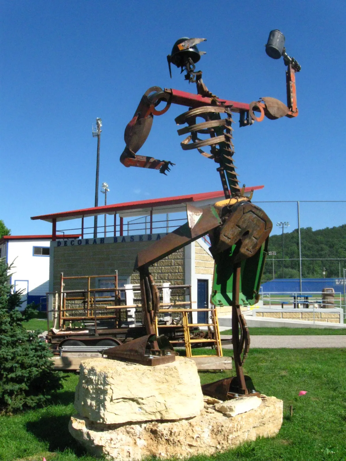 large scale welded found object sculpture of the mythological god, Thor, made from a variety of tractor and farm equipment parts