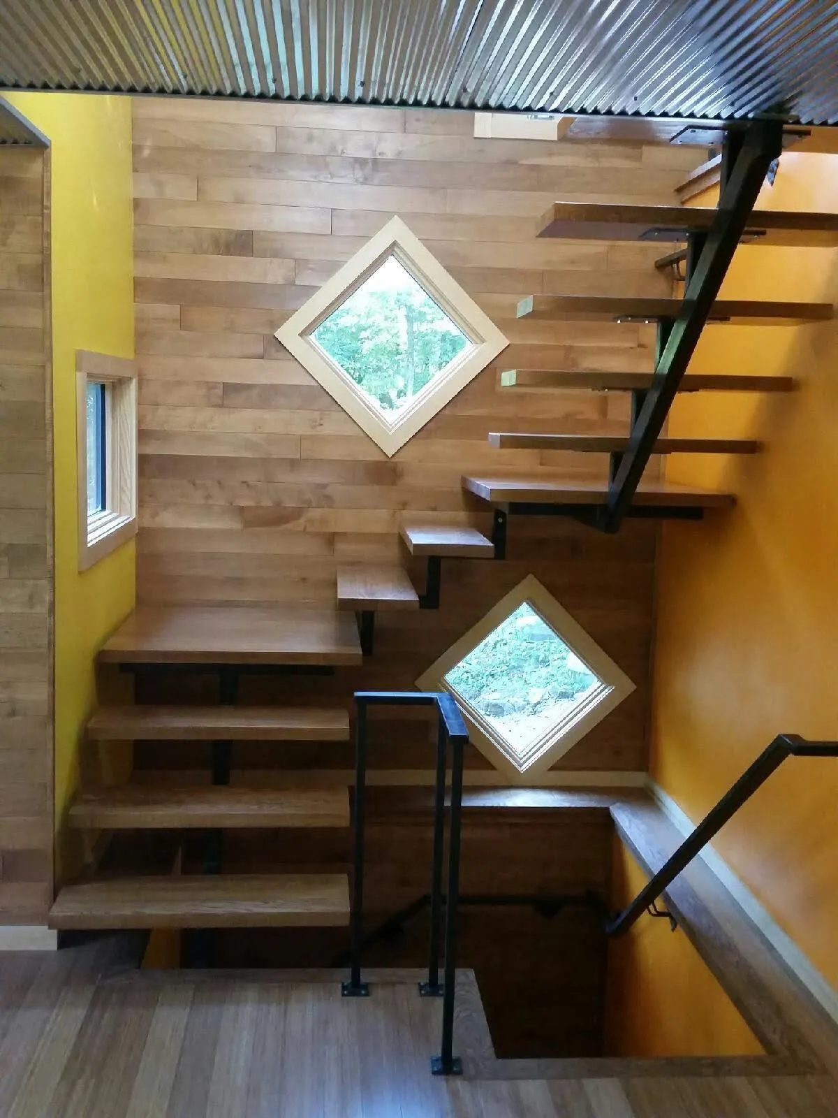 welded steel staircase with two turns in it - wood treads