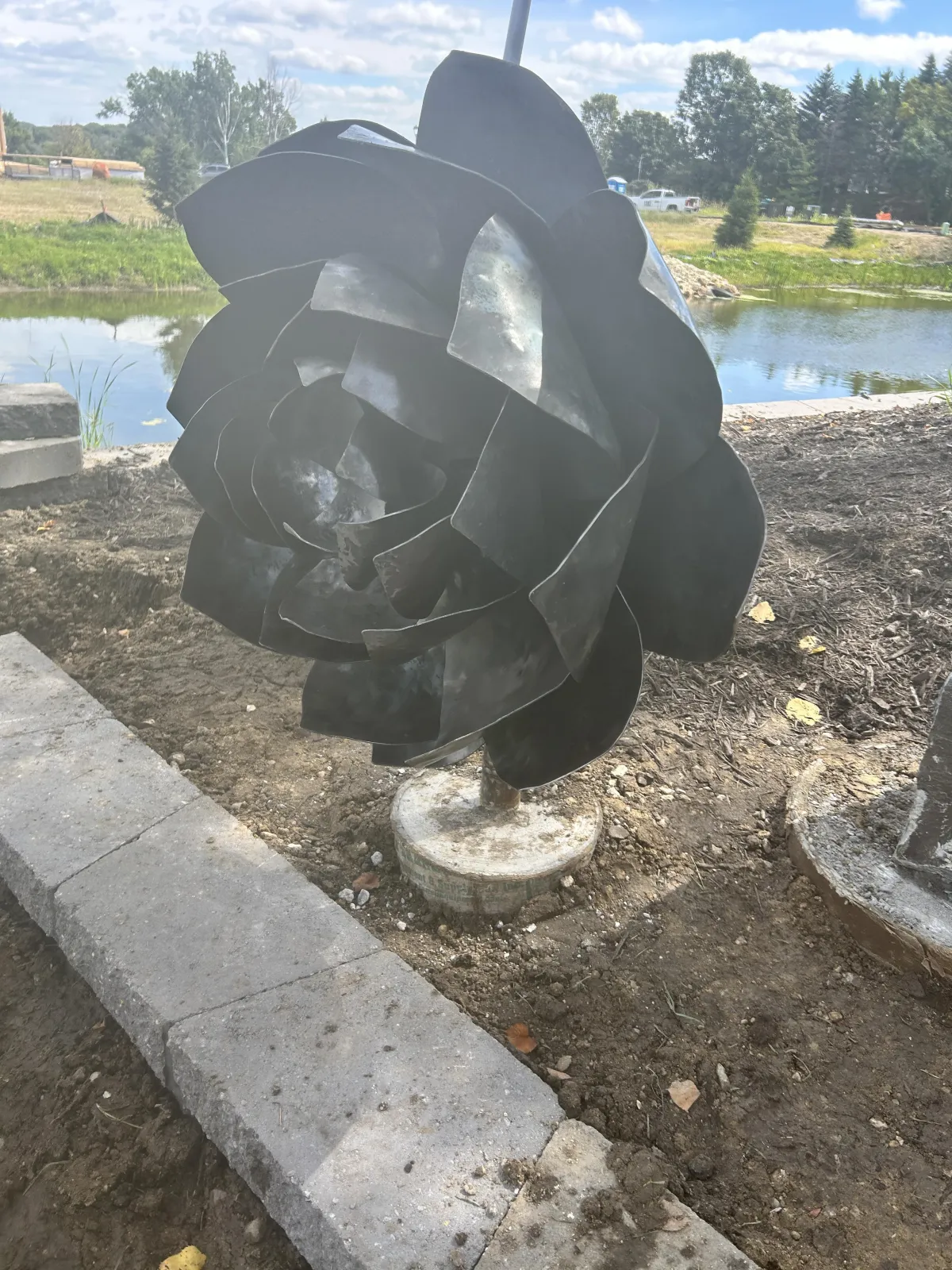 hand forged layers of sheet steel to form the opening petals of a lotus flower